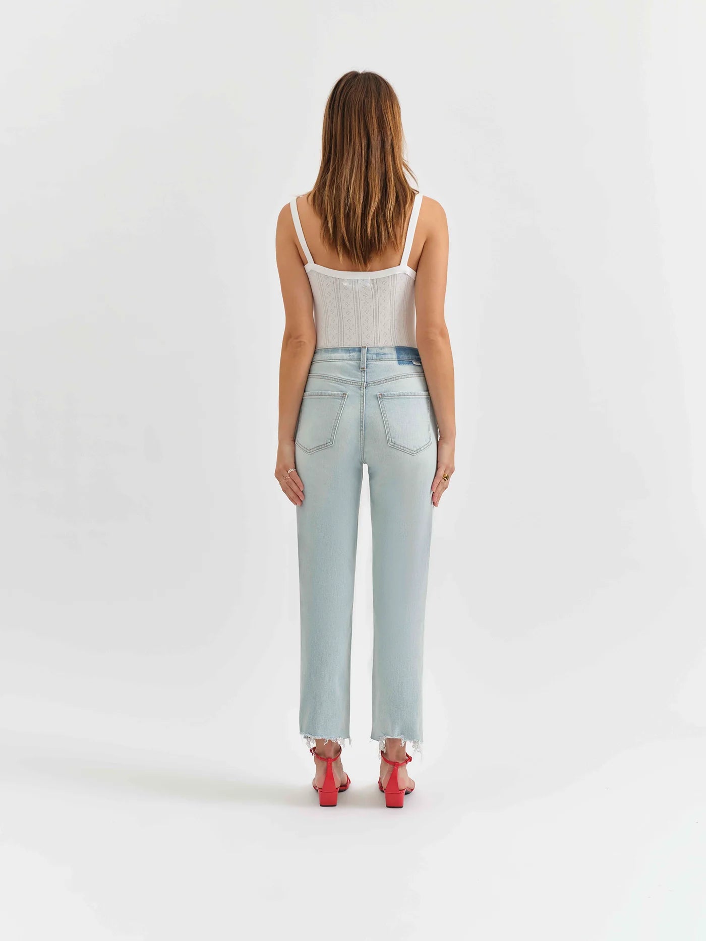 Back view of a model wearing the Swoon wash straight jeans by Daze Denim.