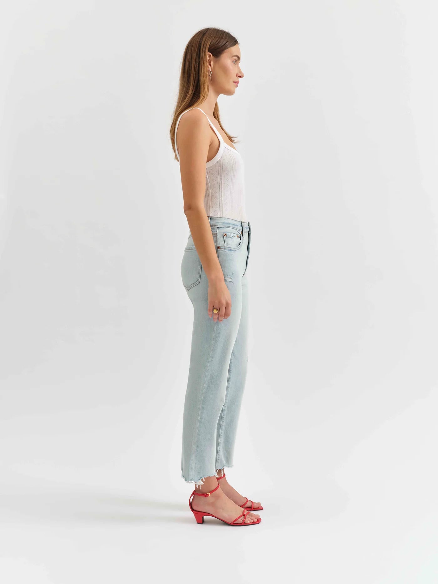 Side view of a model wearing the Swoon wash straight jeans by Daze Denim.