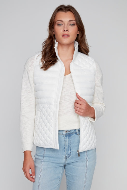 Woman wearing CYC off-white quilted puffer vest with zip front and mock collar.