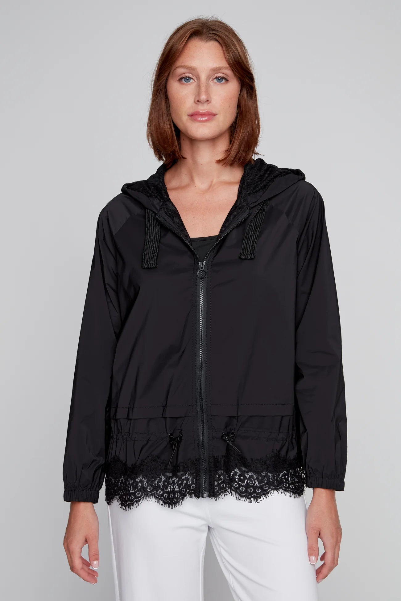 Model wearing a black CYC windbreaker with lace hem and hood.
