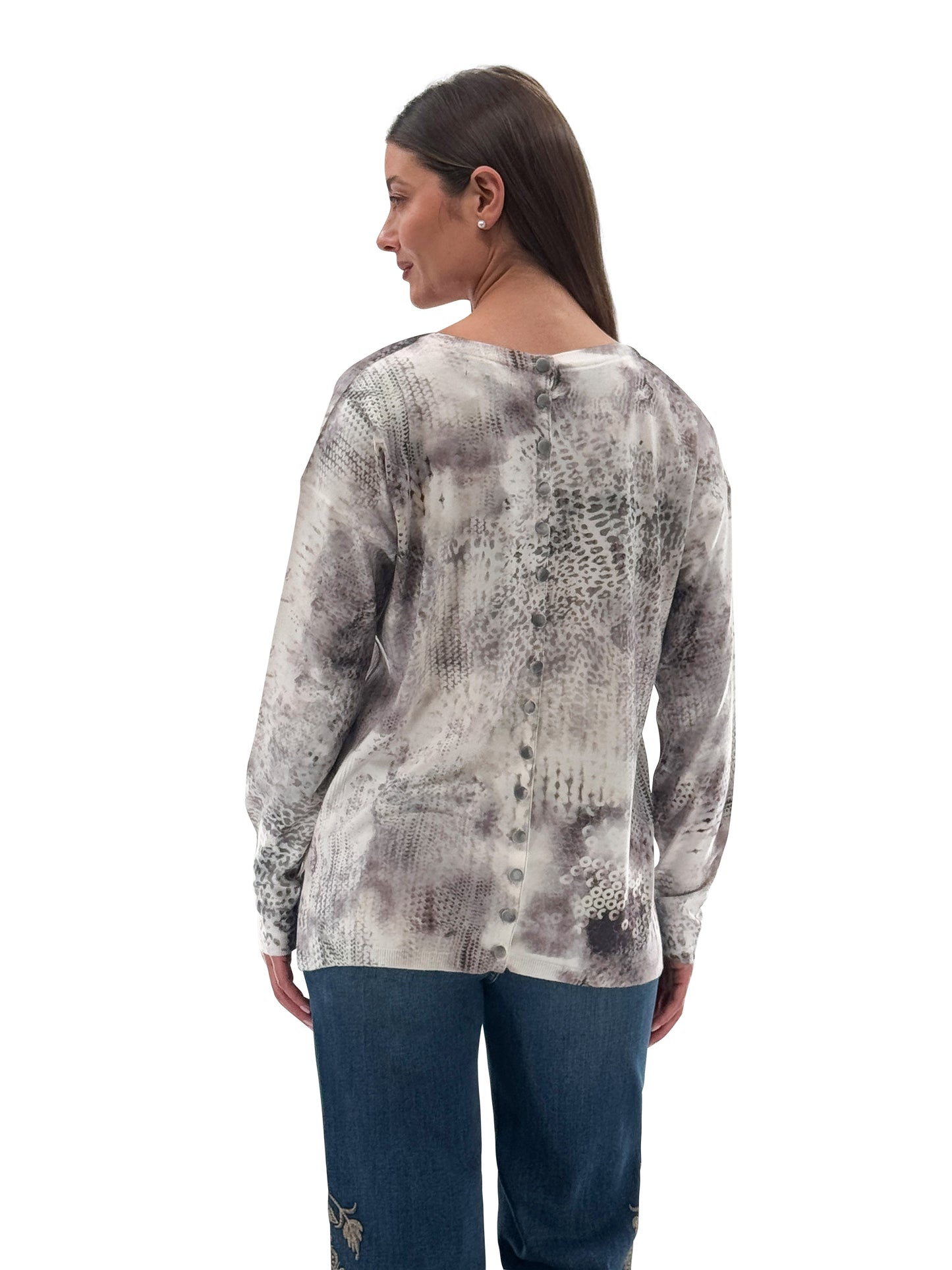 Model wearing Orly cream and grey knit sweater with back button details and front pockets, back view. Available at Gayle’s Fashions boutique in Canada.