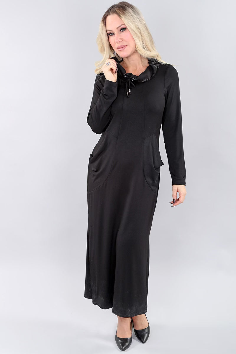Model wearing long black Michael Tyler dress.