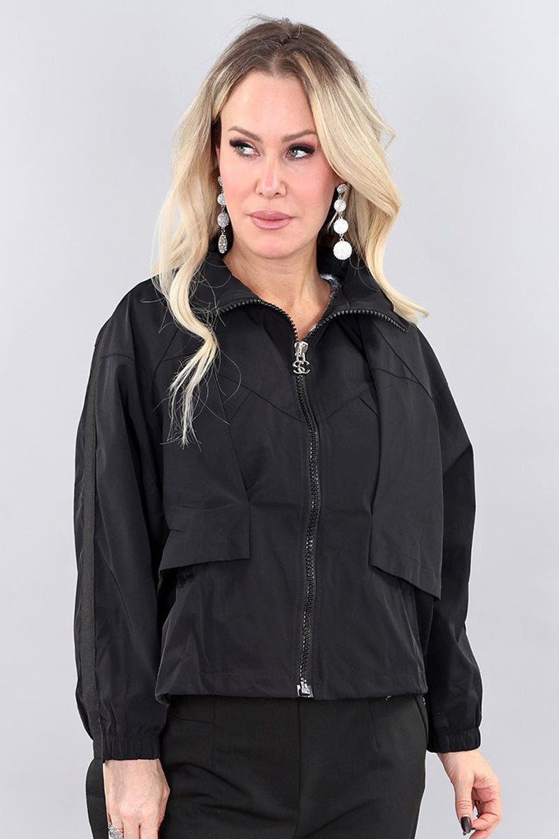 Model wearing black short polyester jacket by Michael Tyler.