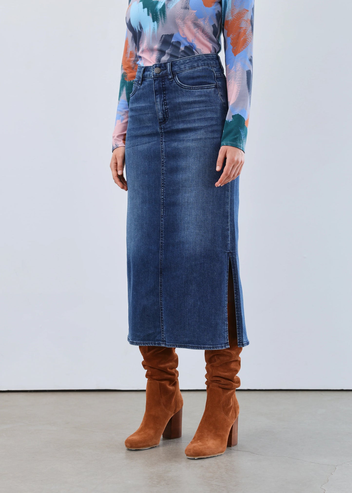 Close-up front view of model in FDJ column skirt with slits, dark wash.