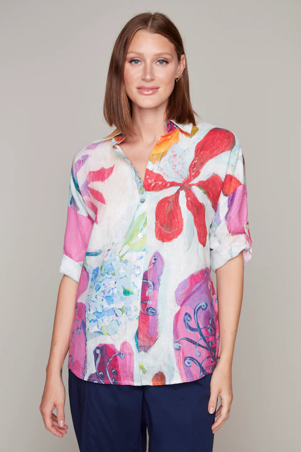Model wearing a red and purple floral linen blouse by Claire Desjardins.