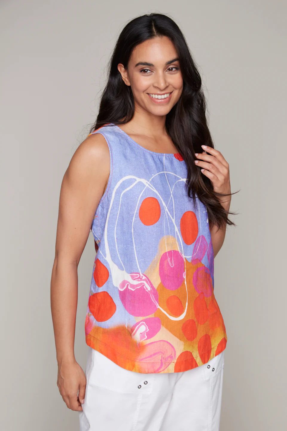 Model wearing Claire Desjardins cotton-linen tank, paired with white pants.