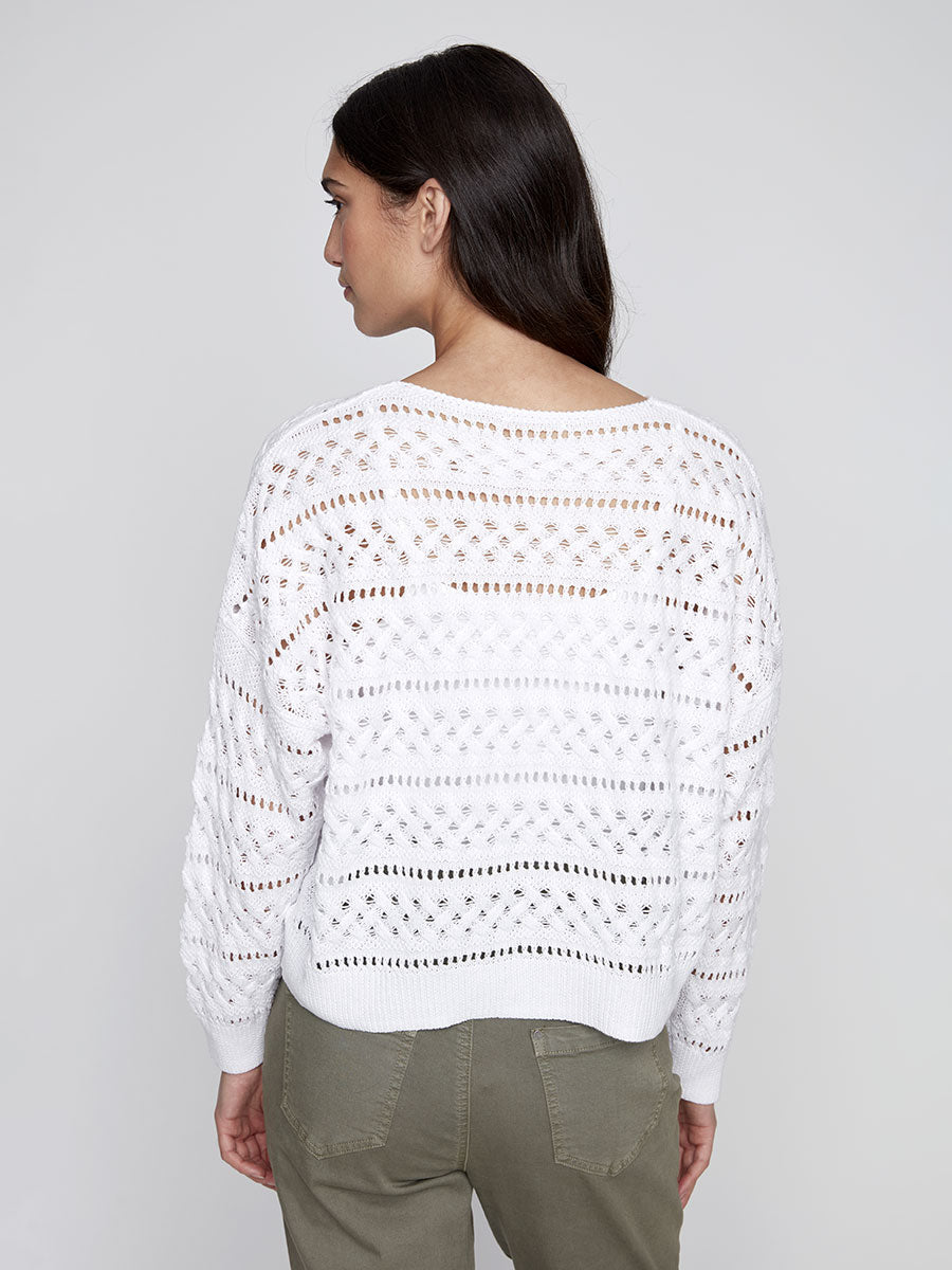Back view of model wearing a white open-knit sweater with horizontal and diamond knit details
