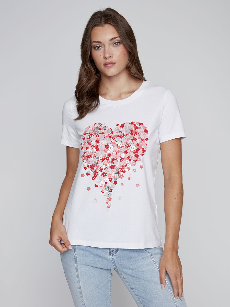 Model wearing CYC white floral graphic tee with red and pink metallic heart design.