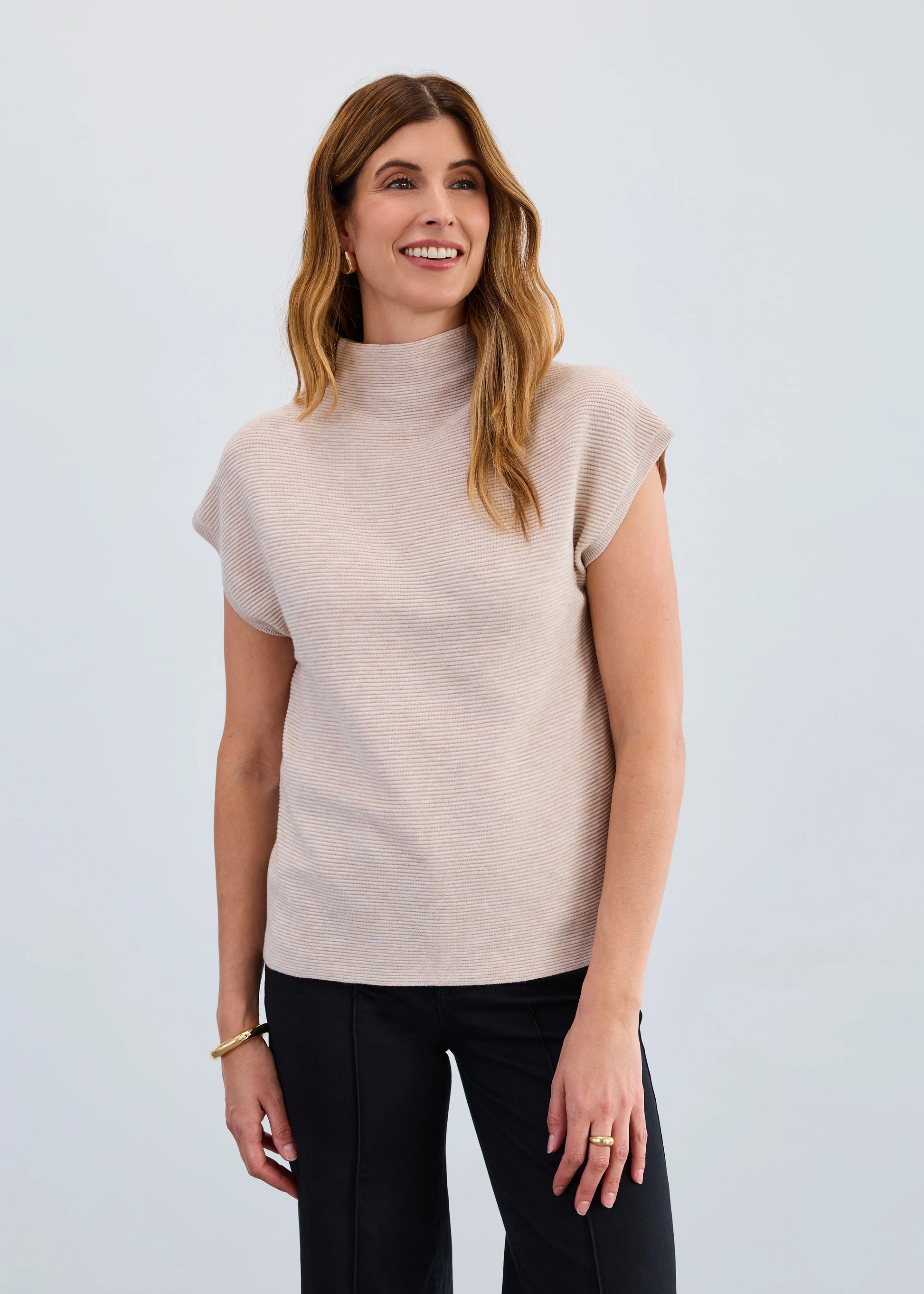 Model wearing FDJ Ottoman Sweater Vest in oat, mock neck sleeveless knit top, Gayle’s Fashions Canada.