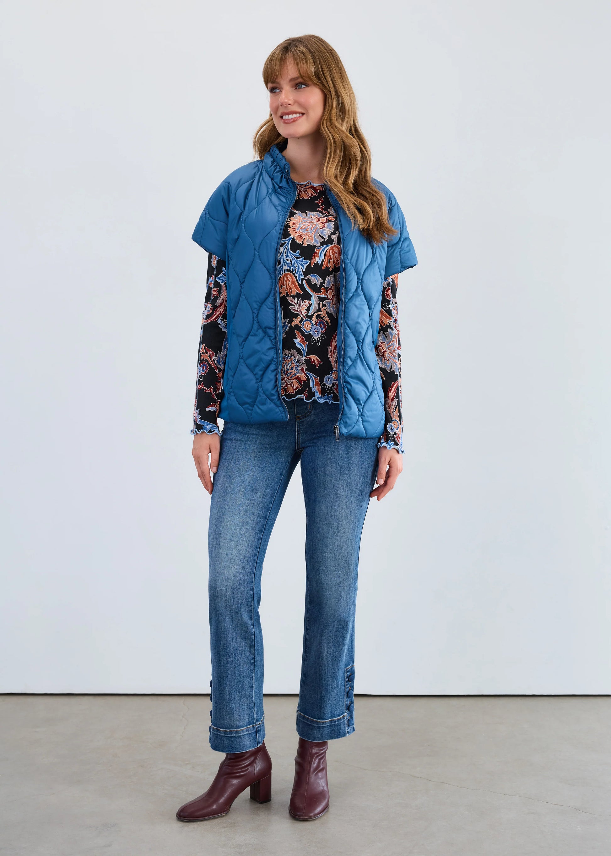 Full front view of a model wearing FDJ's short sleeve puff bomber jacket in indigo, women’s outerwear.