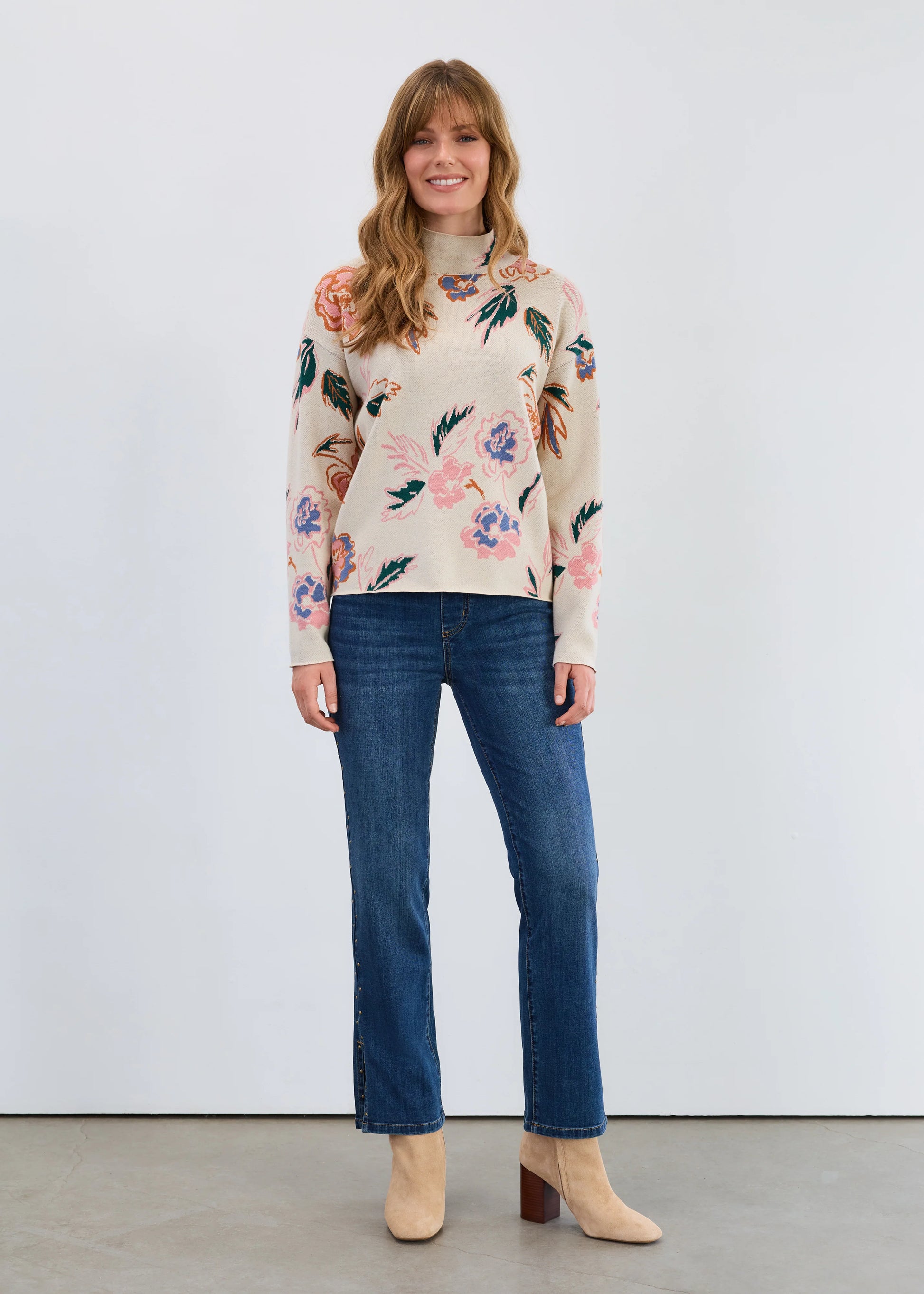 Full front view of model wearing FDJ Bloomsbury mock neck loose fit sweater styled with denim, from Gayle’s Fashions women’s boutique in Canada.
