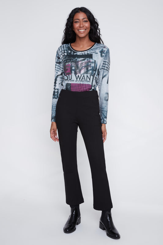 Model wearing CYC's black pull-on pants with zip pockets, paired with a printed knit top.