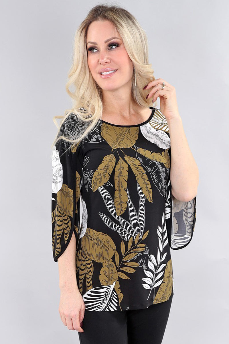 Model wearing black and green leaf pattern ¾ sleeve top by Michael Tyler.