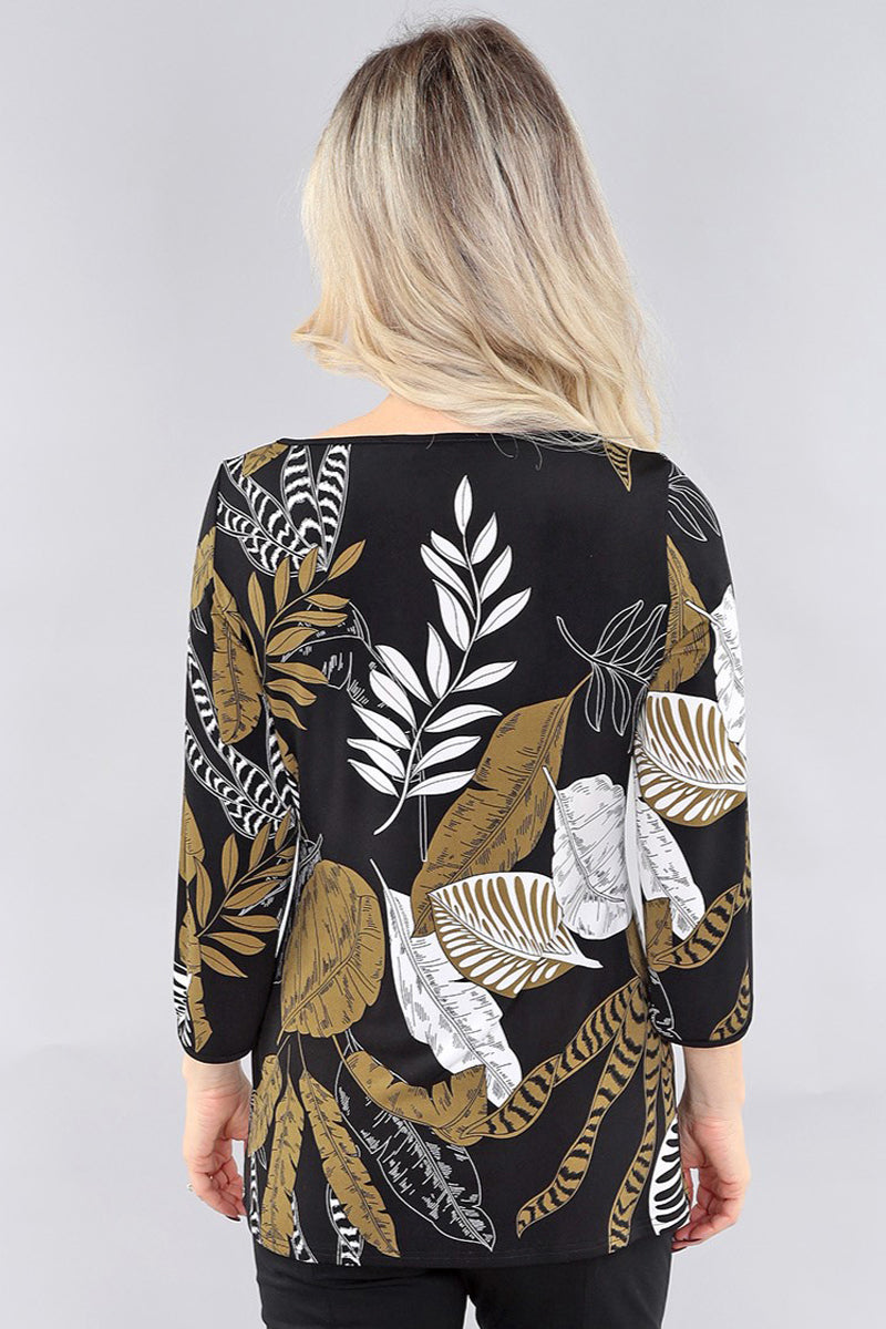Back view of a model wearing black and green leaf pattern ¾ sleeve top by Michael Tyler.
