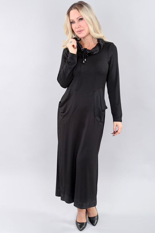 Model wearing long black Michael Tyler dress.