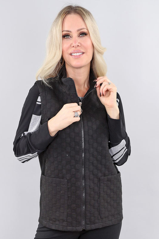 Model wearing black sleeveless zip vest by Michael Tyler.