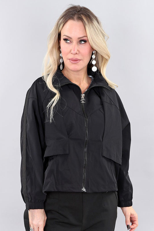 Model wearing black short polyester jacket by Michael Tyler.