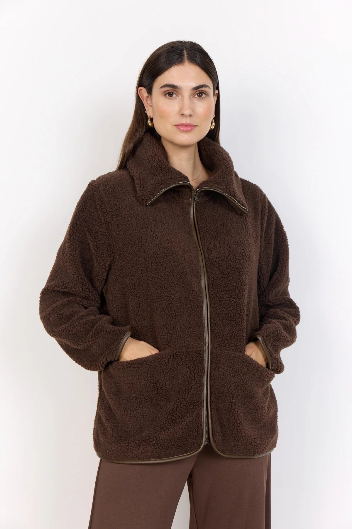 Soya Concept chocolate sherpa bomber with turtleneck collar zipped up.