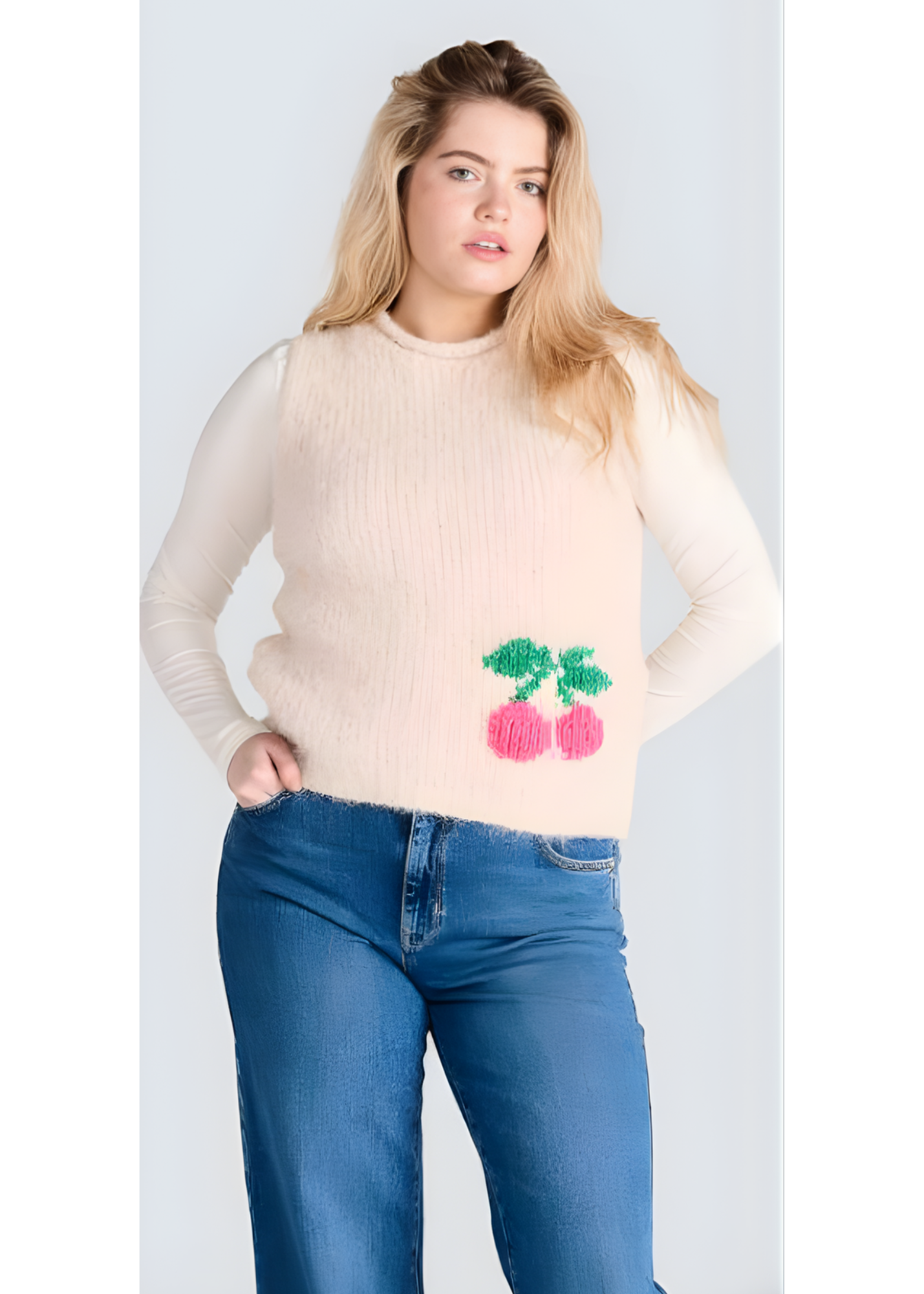 Cream knit vest with waist tie styled over a white blouse by Jessica Laura.