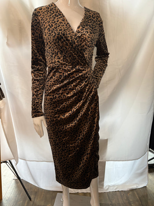 Front view of a mannequin wearing Angeleye's leopard wrap dress.