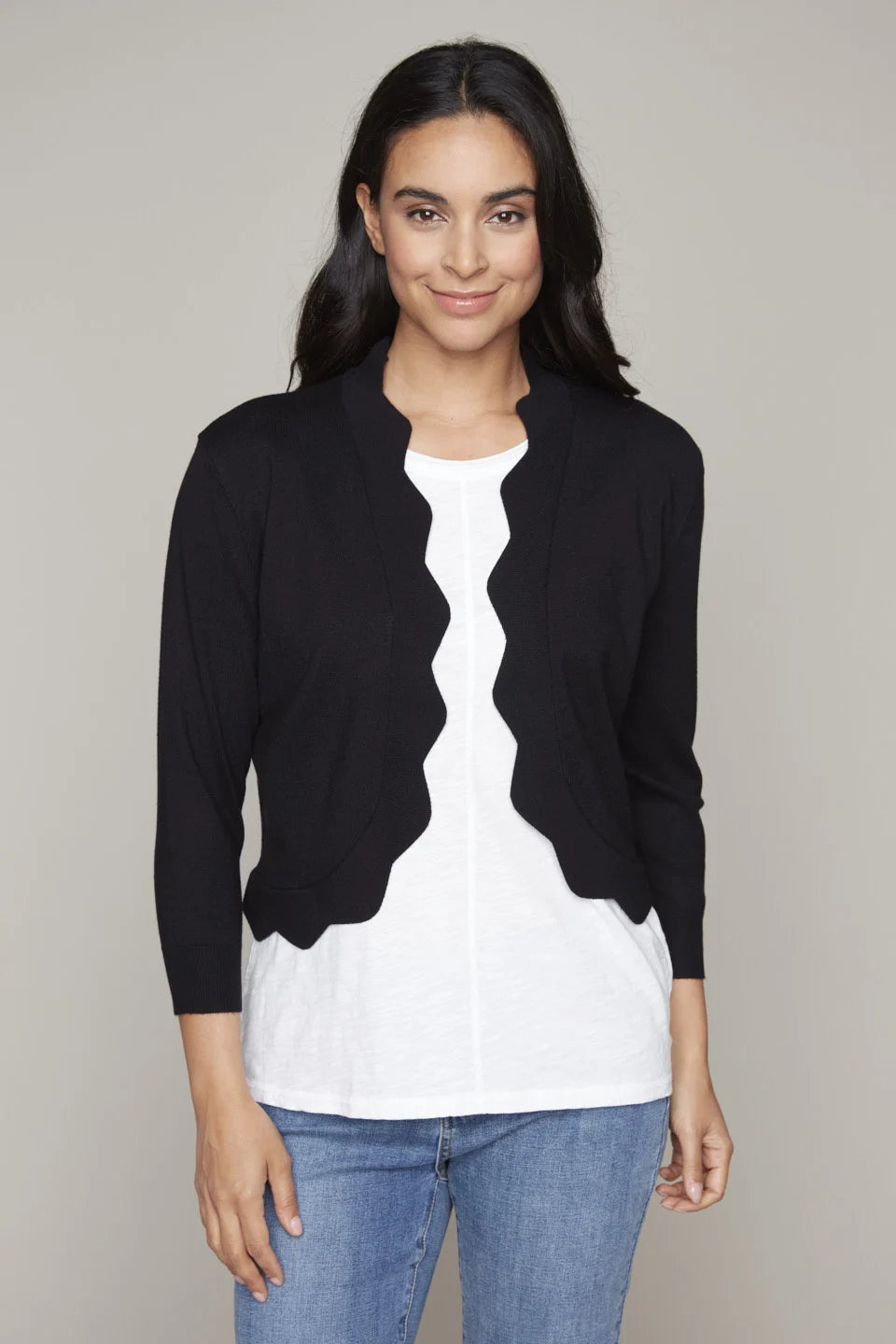 Model wearing Carre Noir's black open-front bolero with zigzag knit.