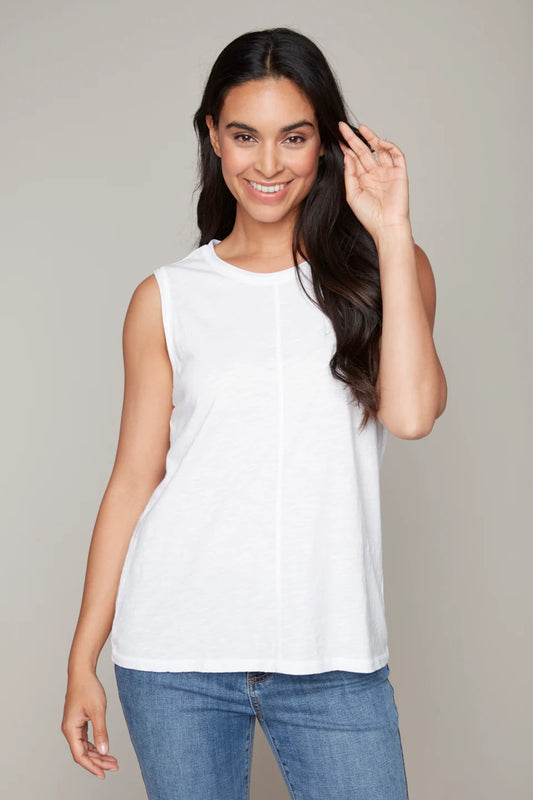 Model wearing a white cotton tank top by Carré Noir.
