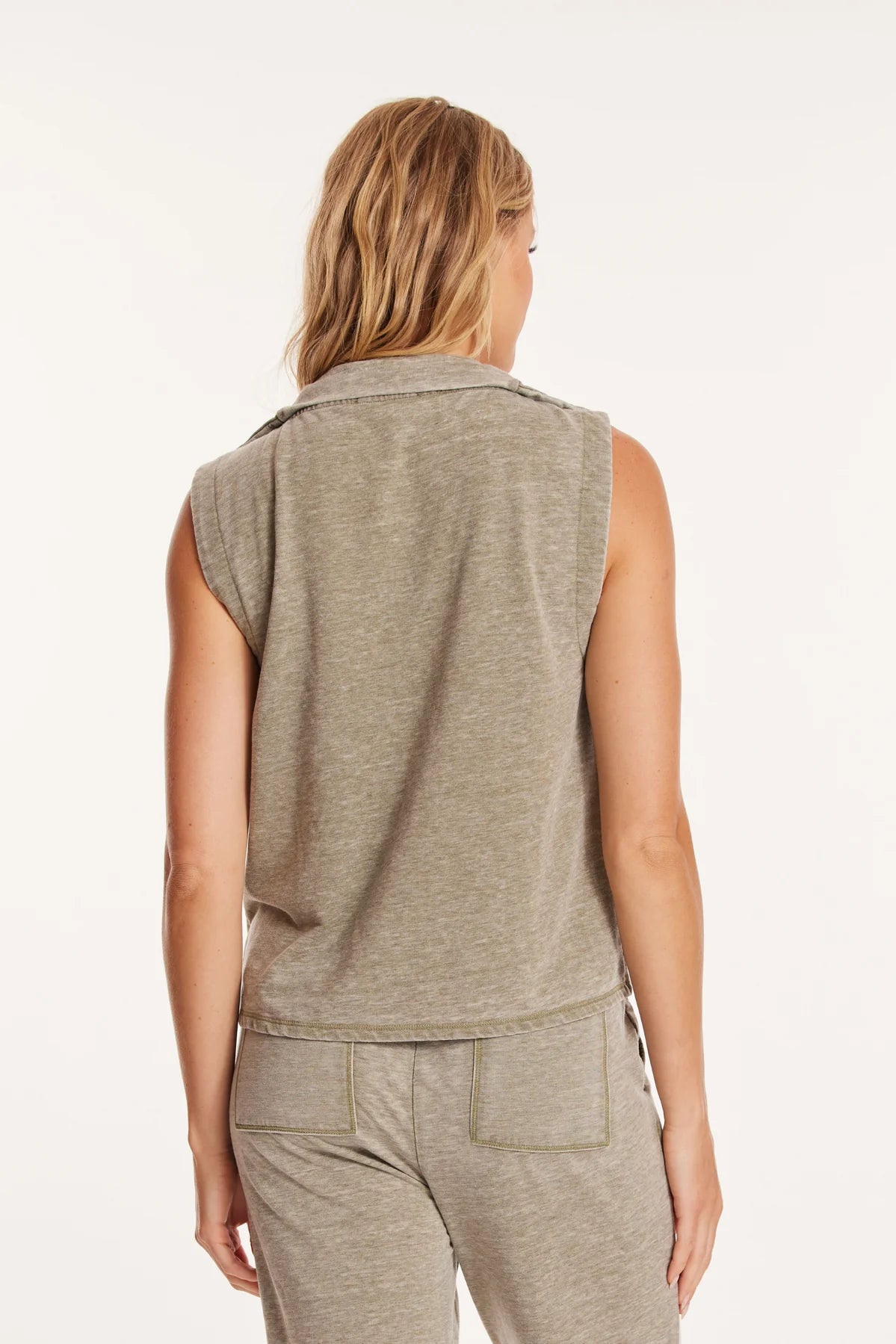 Back view of a model wearing Mododoc 1/4 zip-front vest in the colour Faded Fennel.