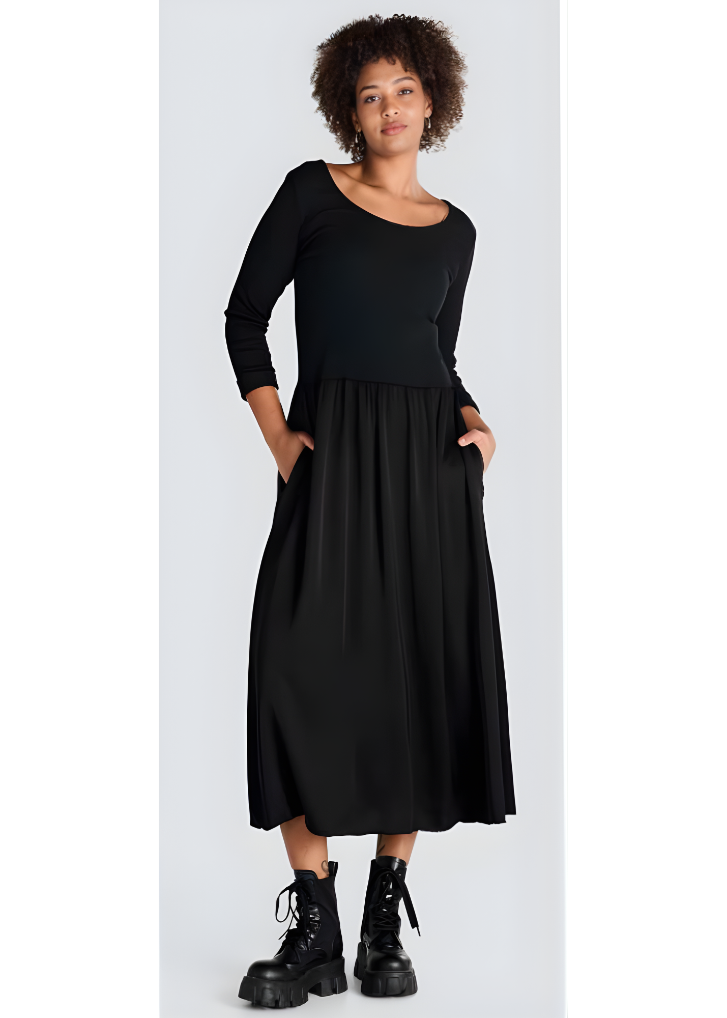 Jessica Laura black long-sleeve scoop-neck dress with pockets, styled with ankle boots.