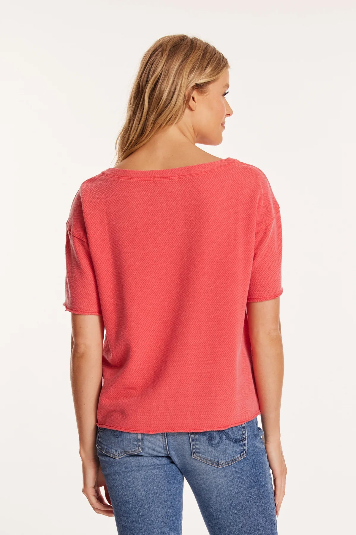 Back view of the tee reveals a clean, straight hemline and soft fabric that falls naturally. The elbow-length sleeves and generous fit continue the relaxed, breathable vibe from all angles.