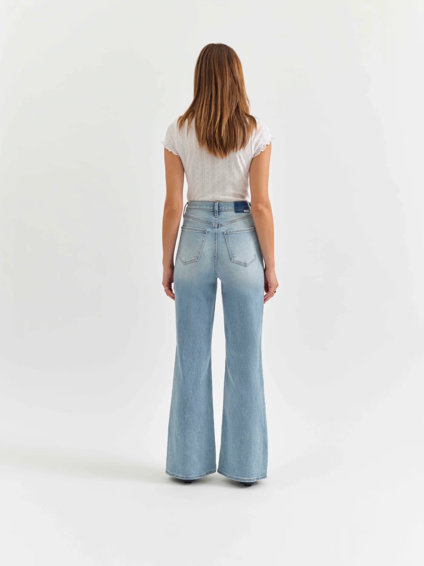 Back view of the Daze Far Out High Rise Wide Leg Jeans in Blooming Vintage. Features a high-rise fit, classic pocket detailing, and a flattering wide-leg shape.