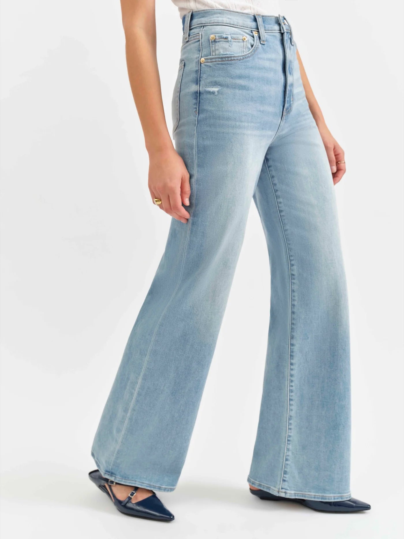 Close-up angled side view of the Daze Far Out High Rise Wide Leg Jeans in Blooming Vintage. Highlights the structured fit through the waist and hips, flaring into a statement wide-leg design.