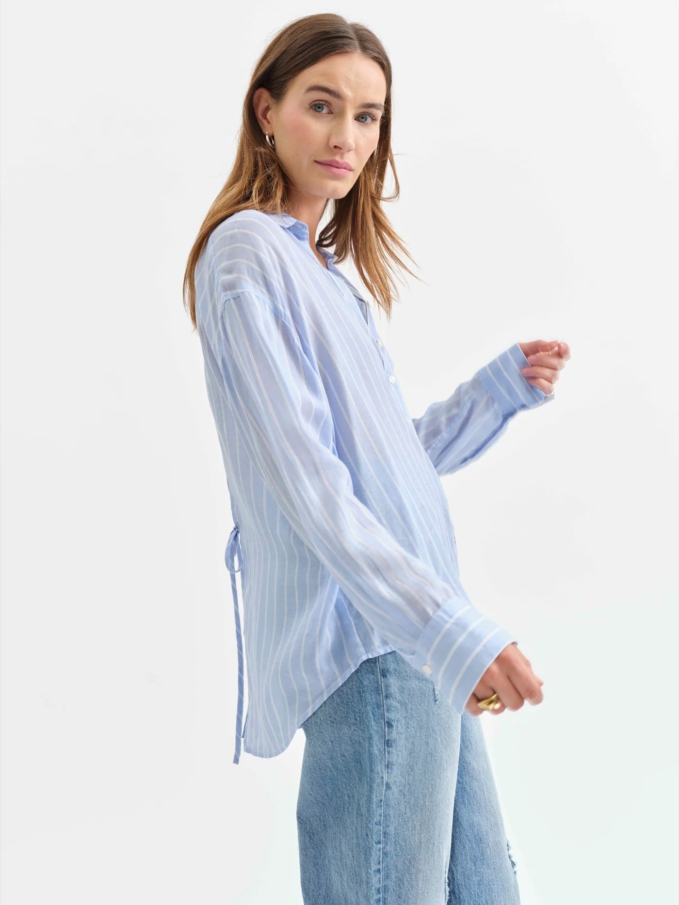 Side angle view of the Daze Lotus Back Tie Long Sleeve Shirt, showing its relaxed silhouette and soft draping fabric.