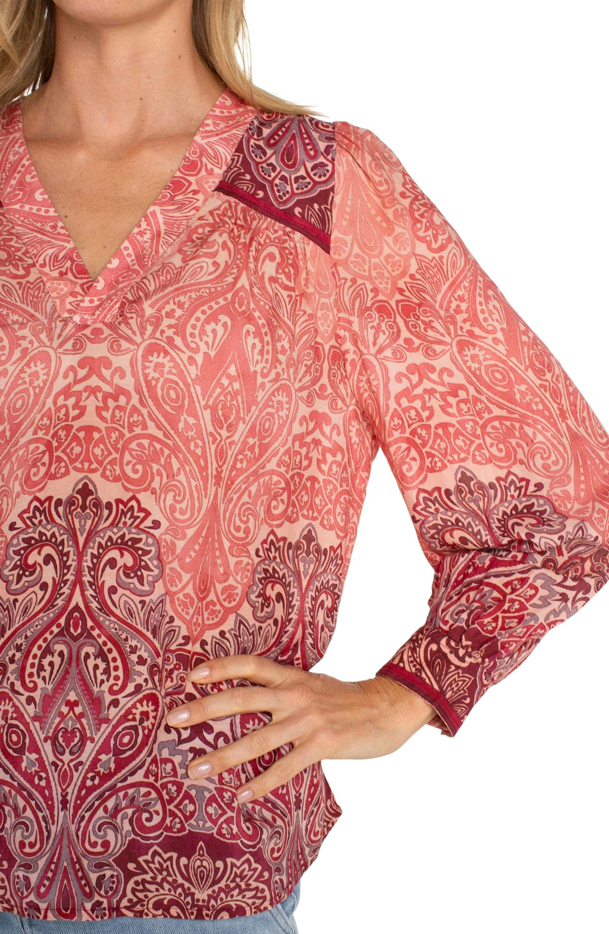 Close-up view of the Liverpool LS V-Neck Popover Woven Blouse, showcasing intricate details of the paisley pattern and contrast shoulder design.