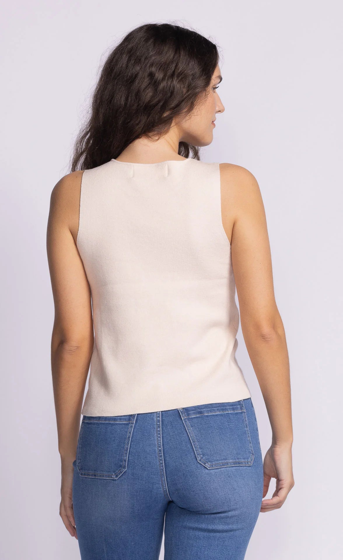 Back view of the Pink Martini Vanessa Top in light peach, displaying its clean, seamless finish and flattering silhouette.