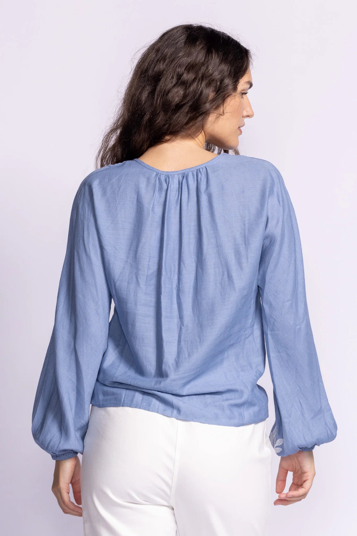 Back view of the Soya Concept Whitney Top in blue, showing its lightweight, flowy fabric with soft pleating for a relaxed fit.