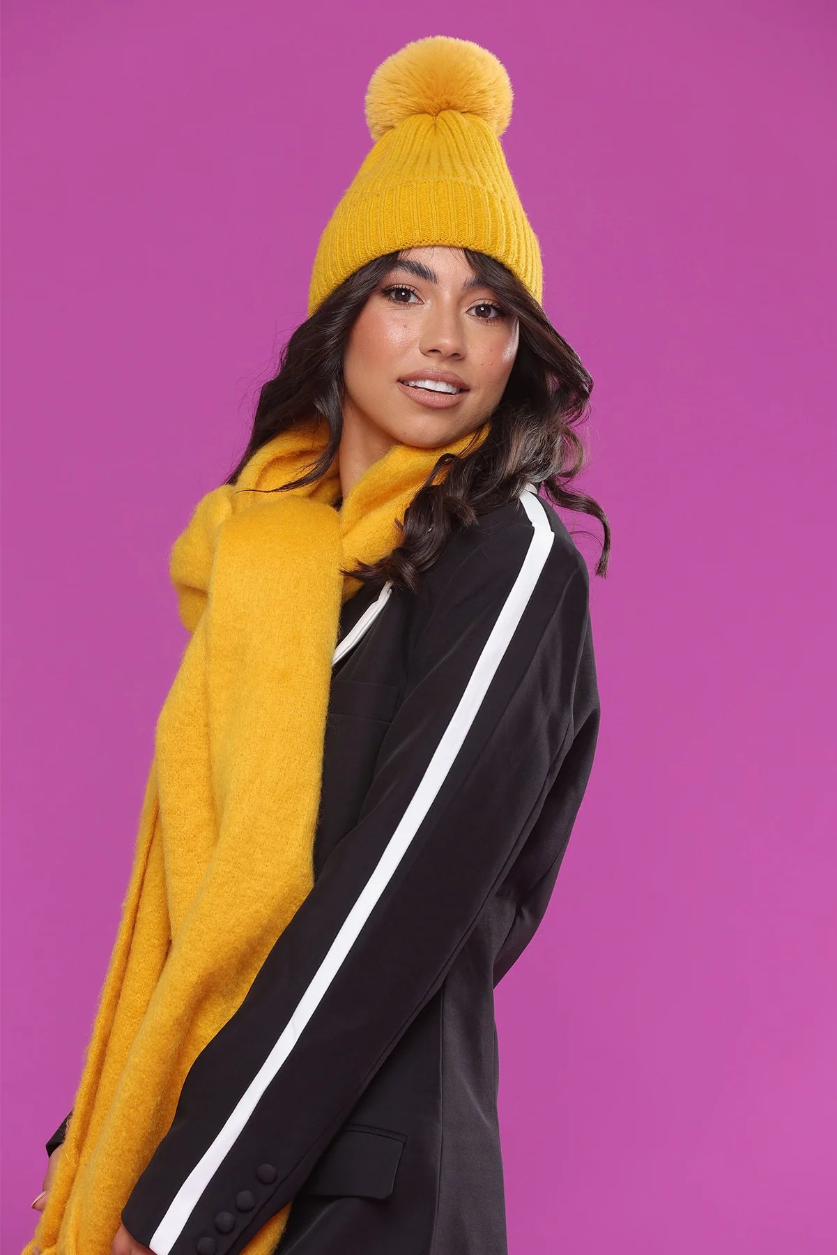 Model wearing the Morgan Taylor Lula Beanie in golden yellow, a bold winter accessory for warmth and style.