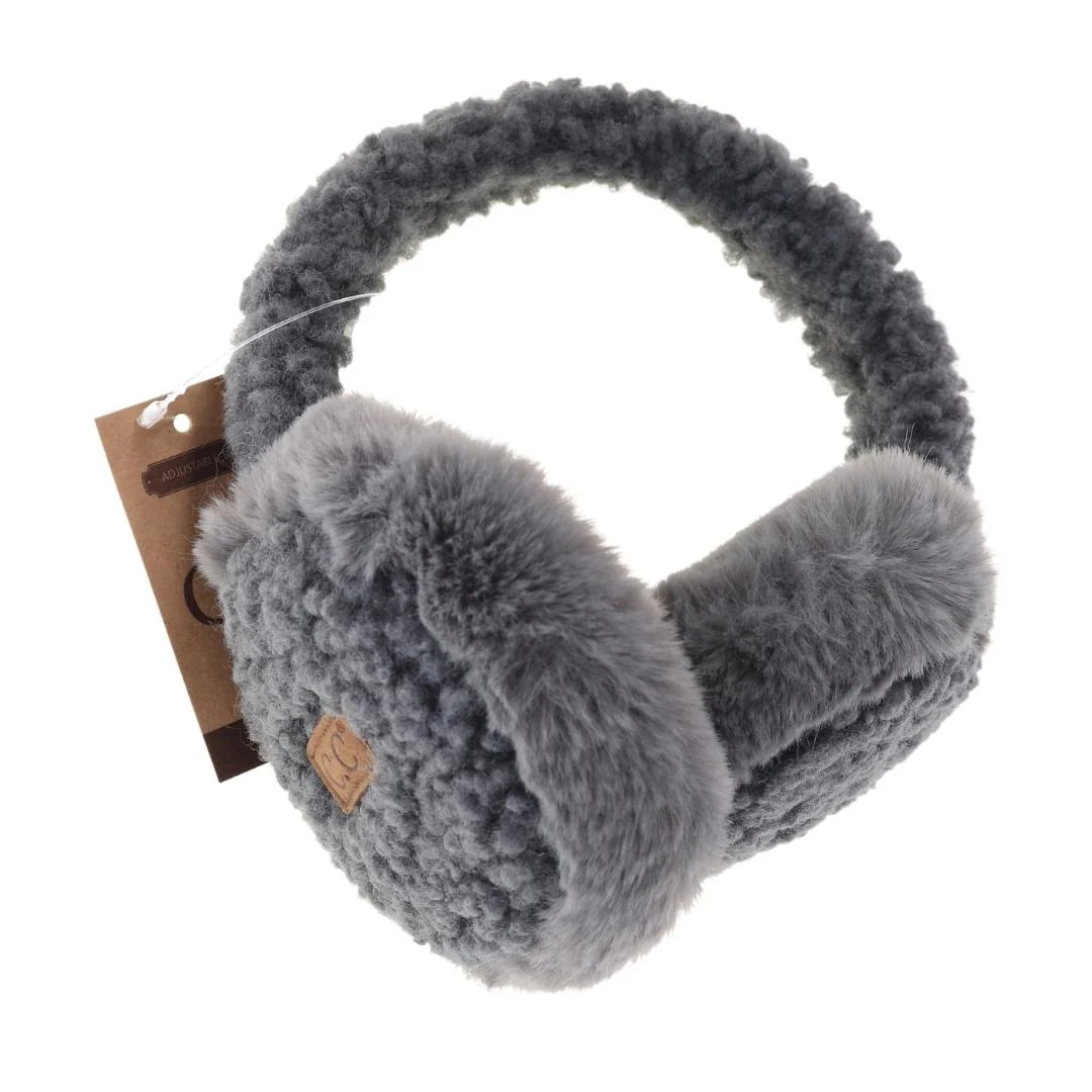 Close-up of C.C Beanie Faux Fur Sherpa Earmuffs in grey, featuring plush ear covers and a soft Sherpa-lined band with a signature leather logo tag.