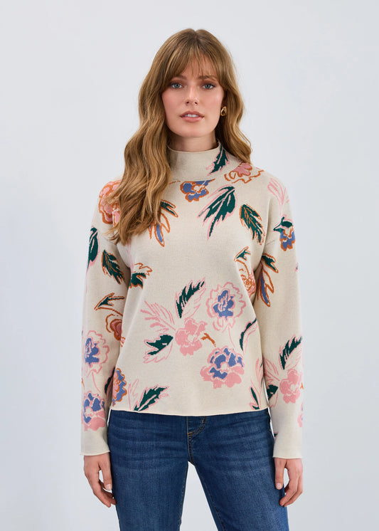Model wearing FDJ Bloomsbury mock neck loose fit floral sweater in soft oatmeal beige, front view. Available at Gayle’s Fashions boutique in Canada.