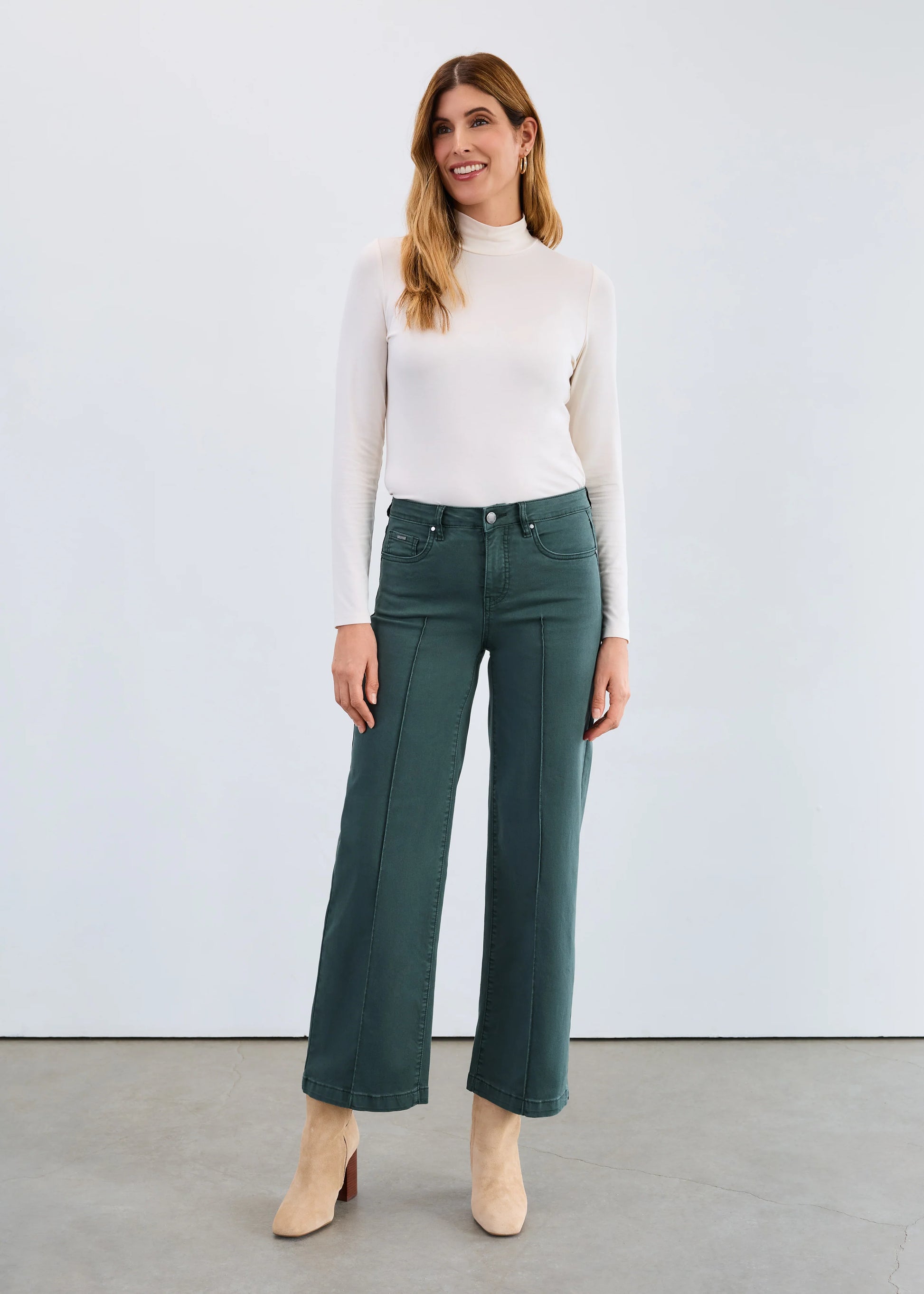 Full front view of model wearing FDJ cream mock neck base top paired with wide-leg pants. Shop Gayle’s Fashions Canada.