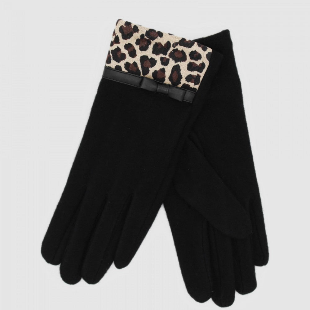 Side view of the Morgan & Taylor Jacqueline Woollen Gloves with a bold leopard print cuff, photographed on a wooden surface.