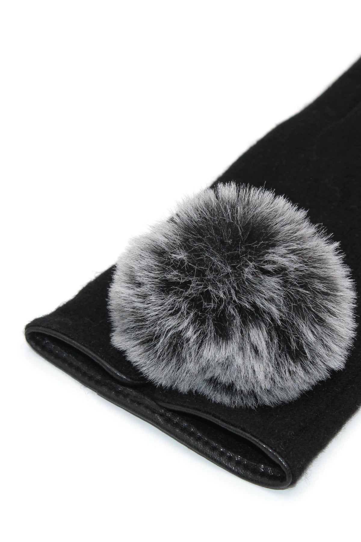 Close-up of a single Morgan & Taylor Antonella Glove in black with a soft grey faux fur pom-pom, displayed flat.