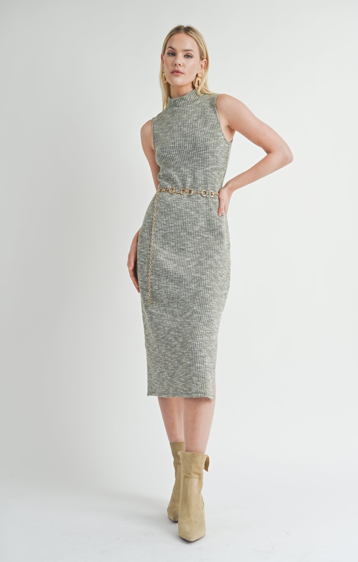 Embrace effortless elegance with the On the Path mock-neck sleeveless midi dress in olive. This dress offers a modern silhouette with its sleek mock neck and midi length, while the sleeveless design makes it perfect for layering or wearing on its own. The rich olive tone adds a natural, earthy vibe, making it a standout piece for both casual outings and dressier occasions.