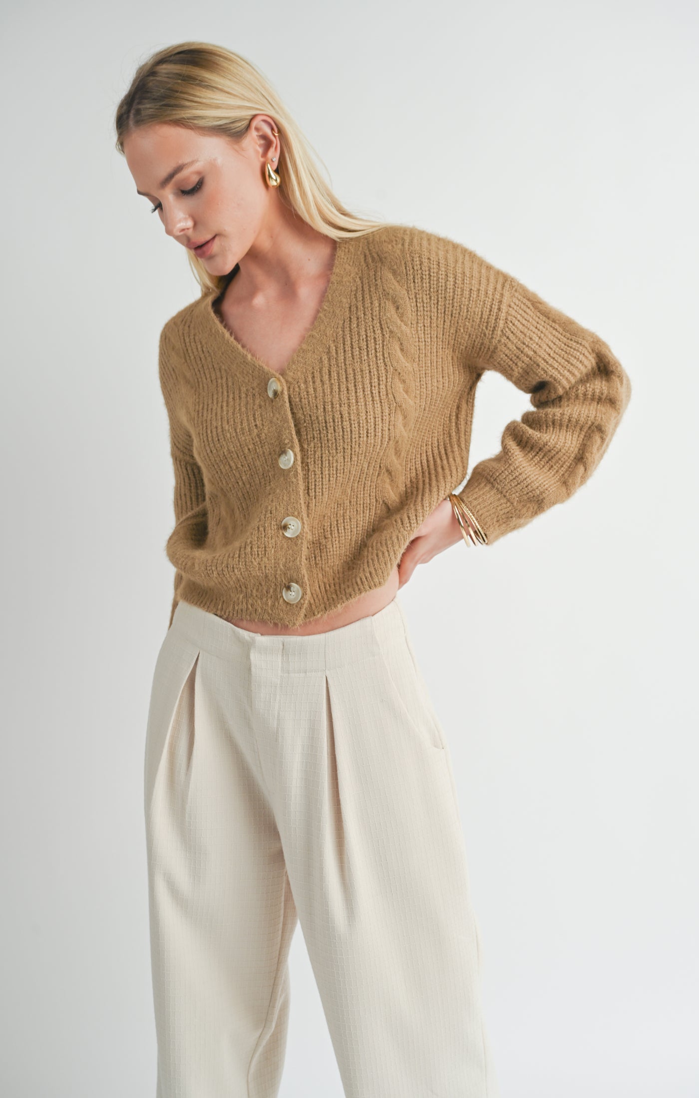 A beautiful light brown (mocha) colored cardigan. 4-button front closure. The length hits just above the hips for a normal to short length. Perfect for cooler summer nights and for the upcoming fall and winter seasons!