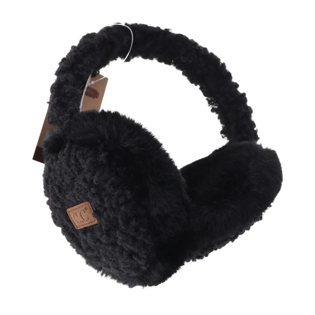 Close-up of C.C Beanie Faux Fur Sherpa Earmuffs in black, showcasing their luxurious faux fur ear covers and cozy Sherpa-lined band with a leather logo tag.