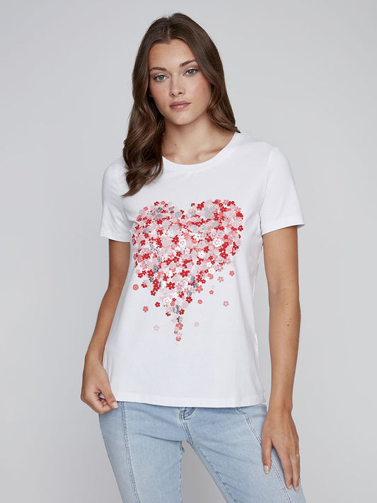 Model wearing CYC white floral graphic tee with red and pink metallic heart design.